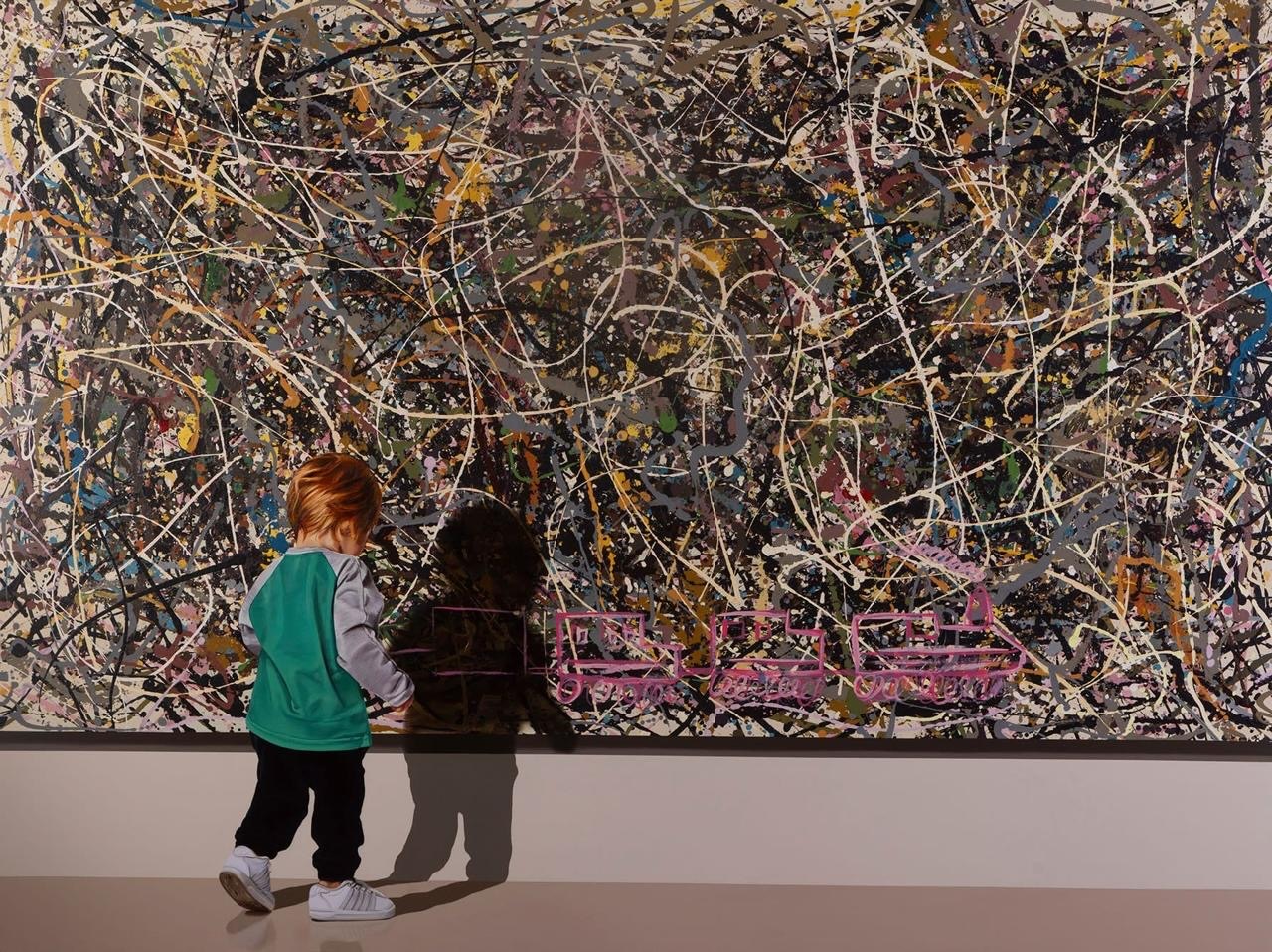 A child contemplating a large abstract painting.